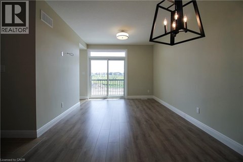 A room with a wooden floor and a large window.