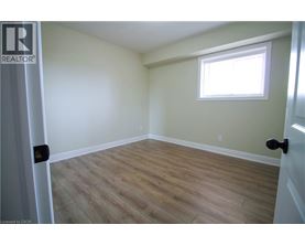 A room with a window and wooden flooring.
