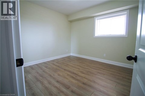 A room with a window and wooden flooring.