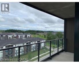 A balcony with a view of apartment buildings.