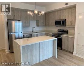 A kitchen with a white island in the middle.