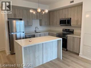 A kitchen with a white island in the middle.