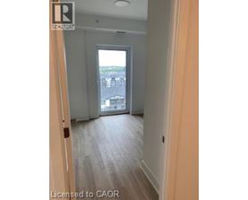 A hallway with a door leading to a balcony.
