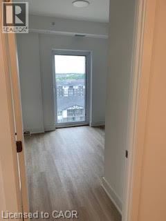 A hallway with a door leading to a balcony.