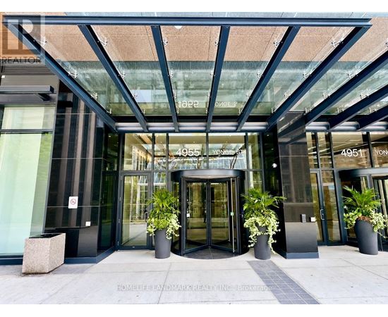 The front of a building with a glass entrance and a sign that reads 4951.
