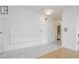 A white room with a door and a wall with a sign that says "REALTOR".