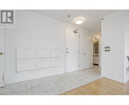 A white room with a door and a wall with a sign that says "REALTOR".