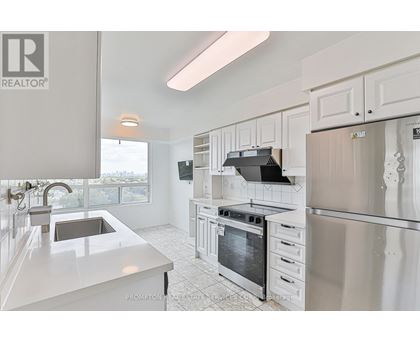 A kitchen with white cabinets and appliances.