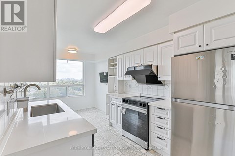 A kitchen with white cabinets and appliances.