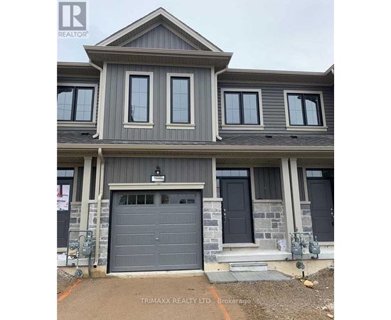 A modern house with a grey garage door is for sale.