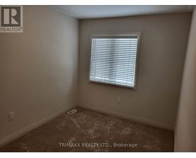 A room with a window and carpeted floor.