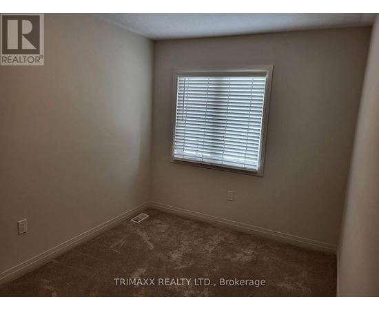 A room with a window and carpeted floor.