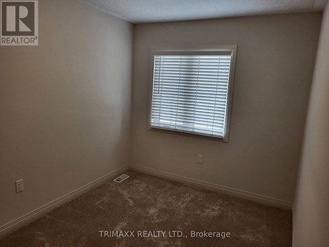 A room with a window and carpeted floor.