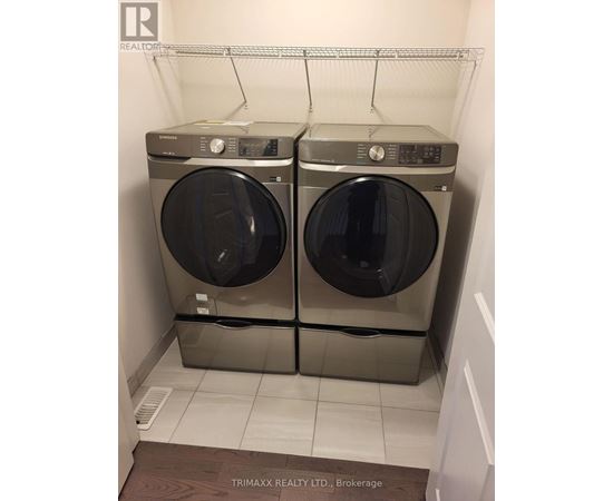 Two front loading washing machines in a small laundry room.