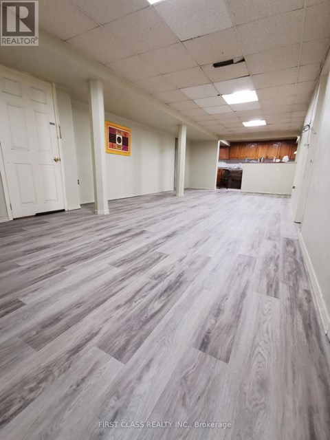 A room with wooden flooring and white walls.