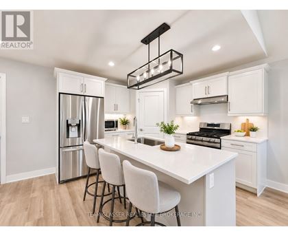 A modern kitchen with white cabinets and a large island.