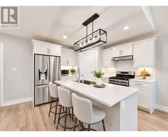 A modern kitchen with white cabinets and a large island.
