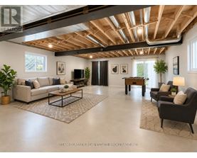 A spacious living room with a high ceiling and wooden beams.