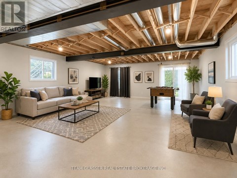 A spacious living room with a high ceiling and wooden beams.