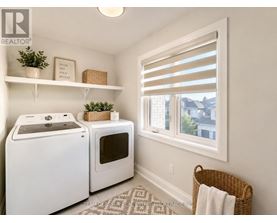 A small laundry room with a washer and dryer.
