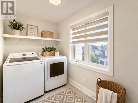 A small laundry room with a washer and dryer.