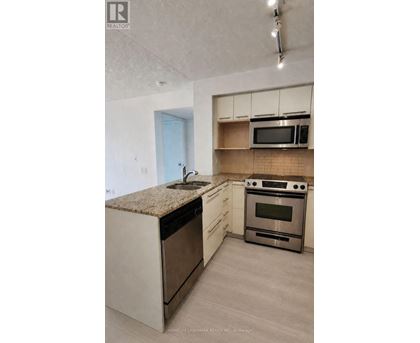 A kitchen with a stove top oven and microwave.
