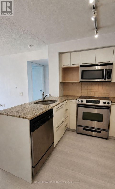 A kitchen with a stove top oven and microwave.