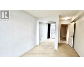 A room with a sliding glass door leading to a balcony.