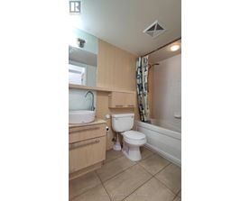 A small bathroom with a toilet, sink, and bathtub.