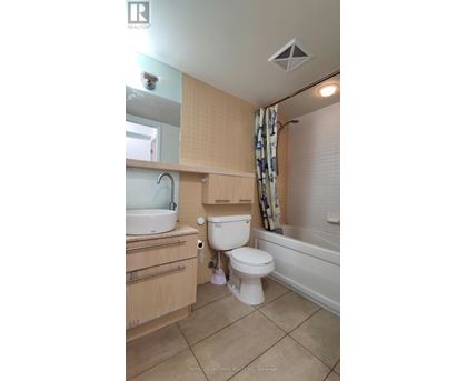 A small bathroom with a toilet, sink, and bathtub.
