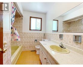 A small bathroom with a toilet, sink, and bathtub.