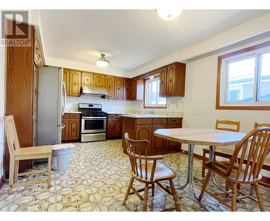 A kitchen with a table and chairs.