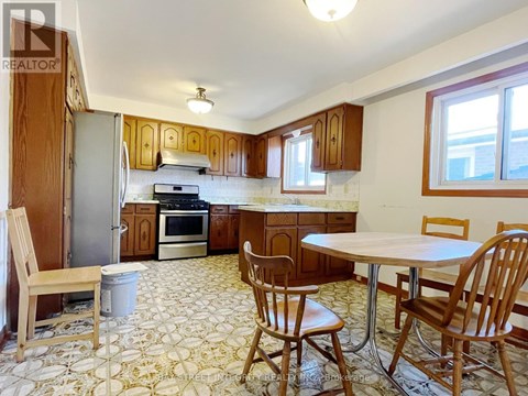 A kitchen with a table and chairs.