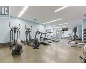 A gym with a variety of equipment including treadmills, elliptical machines, and weight machines.