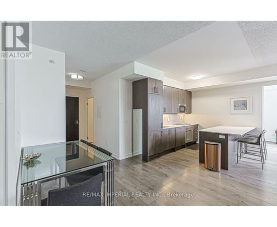 A modern kitchen with a glass table and chairs.