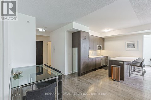 A modern kitchen with a glass table and chairs.