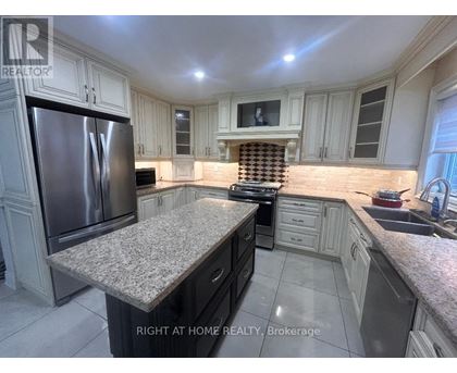A kitchen with granite countertops and stainless steel appliances.