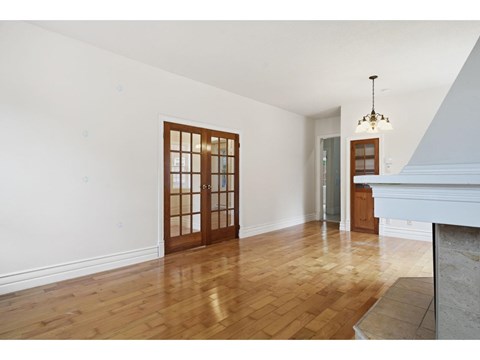 A room with wooden floors and a chandelier.