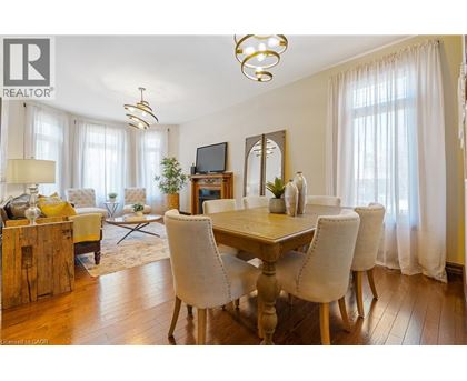 A well-lit dining room with a wooden table and chairs.