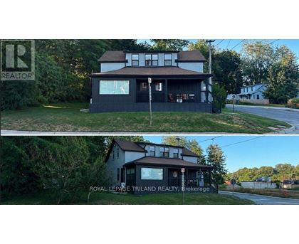 A house with a sign that says "REALTOR" in the top left corner.
