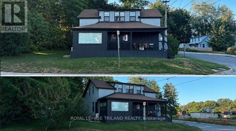 A house with a sign that says "REALTOR" in the top left corner.
