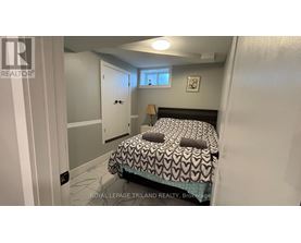 A bedroom with a bed, a window, and a door.