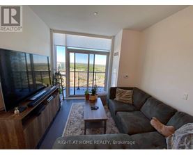 A living room with a flat screen TV and sliding glass doors.