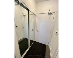A white bathroom with a glass door and a towel rack.
