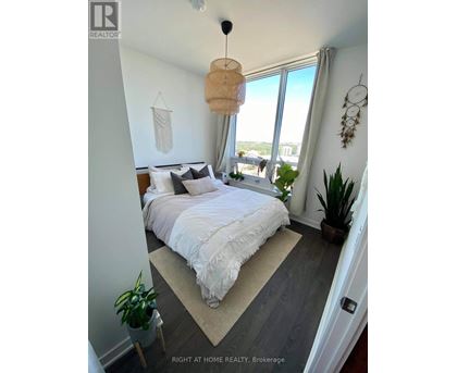A bedroom with a large bed and a view of the city.