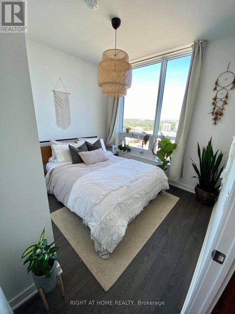 A bedroom with a large bed and a view of the city.