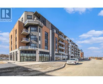 A modern apartment building with a car parked in front.