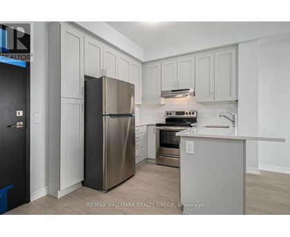A kitchen with a stainless steel refrigerator and a stove top oven.