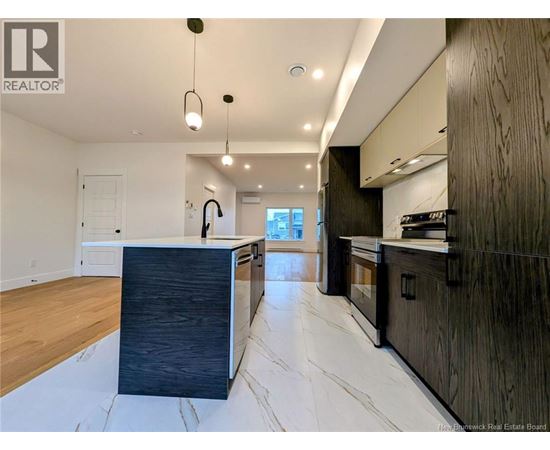 A modern kitchen with dark wood cabinets and a marble floor.