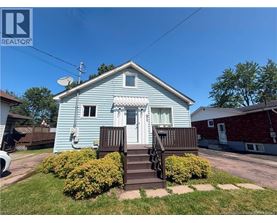 A blue house with a white door and a small porch.
